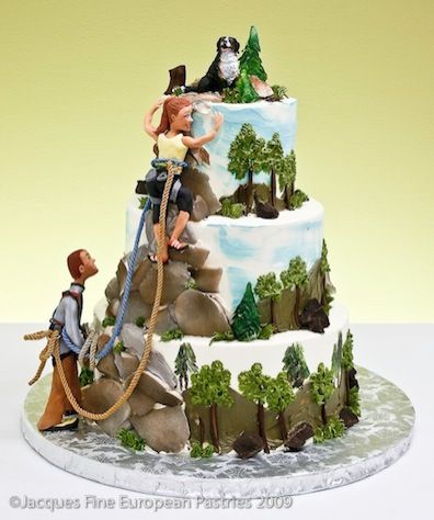 A three-step cake decorated with rocks, trees, and a male and a female climbers