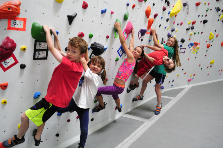 Group of children climbing a wall