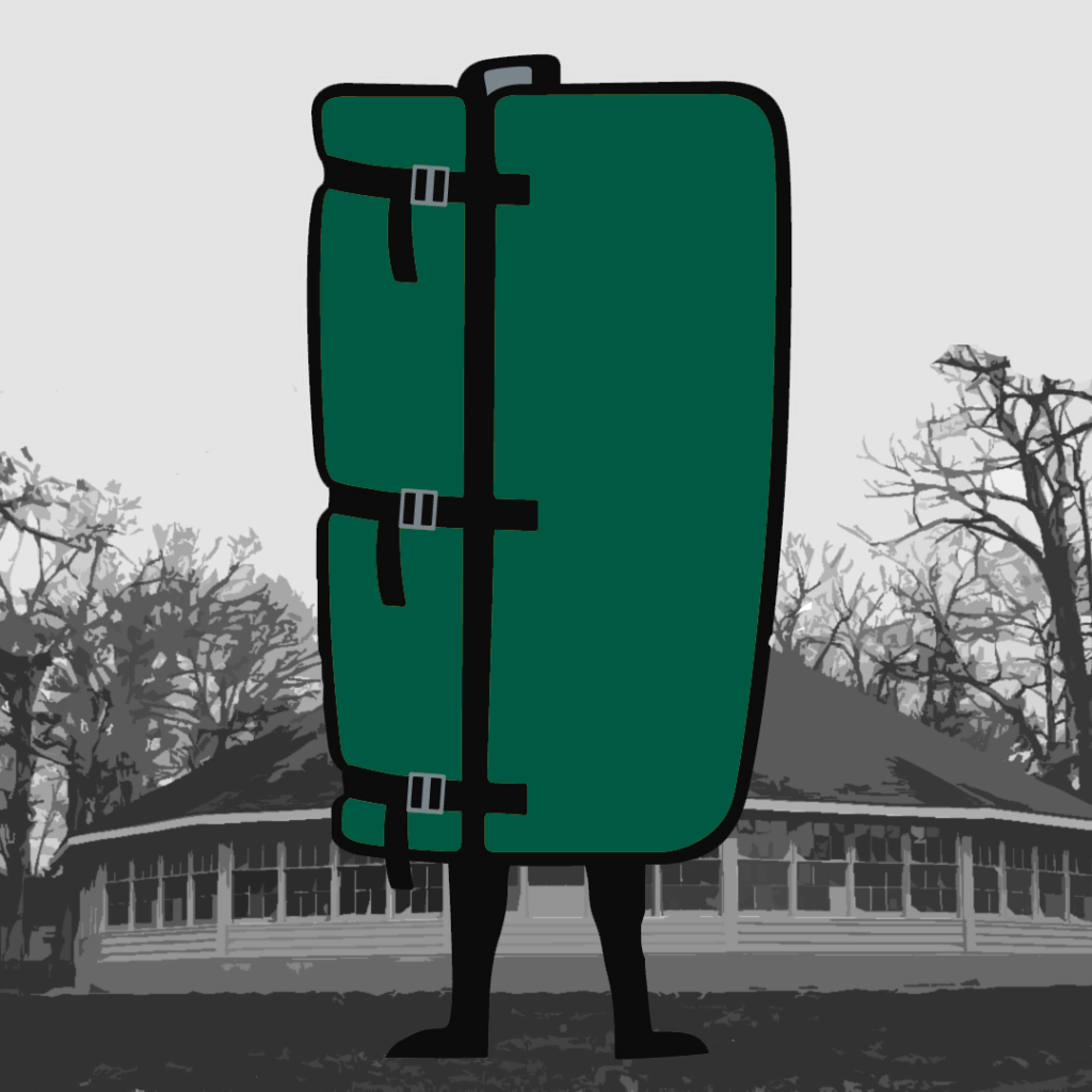 A green-colored climbing crash pad worn by a person showing the back view and standing in front of a building surrounded by trees.